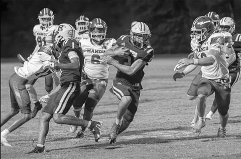 Members of the Mamou defense including Neahemiah Freeman (17) and Decoreyon Arceneaux (6) try to take down a Rayne ball carrier in a game last Friday night. (LSN photo by Lisa Soileaux)