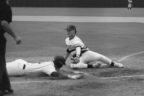 Trojan baserunner Briggs Ardoin (6) slides into home plate ahead of the tag from Mamou pitcher Wyatt Johnson (8). (Gazette photo by Rhett Manuel)