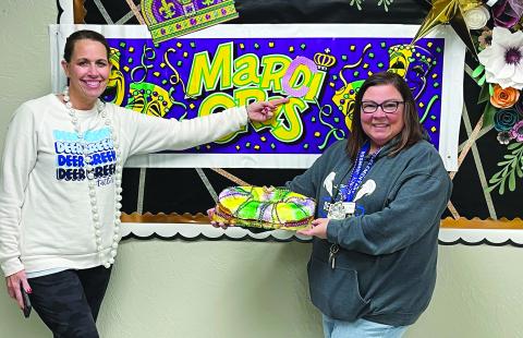 MARCI GRAS IN OKLAHOMA - Prairie Vale Elementary congratulated Dr. Marcy Boudreaux-Johnson after she was named District Teacher of the Year with a special “Marci Gras” celebration, complete with king cake and a parade down the school halls to Mardi Gras music. Boudreaux-Johnson is shown with Prairie Vale Elementary School administrator Michelle Anderson (left). (Photo courtesy of Dr. Marcy Boudreaux-Johnson)