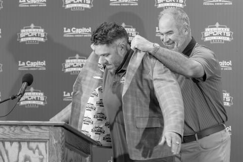 Todd McClure (left) receives his Louisiana Sports Hall of Fame jacket from LSHOF President and Chief Executive Officer Ronnie Rantz (right) during an introductory press conference on Thursday, June 25, in Natchitoches. (Photo courtesy of LSHOF)