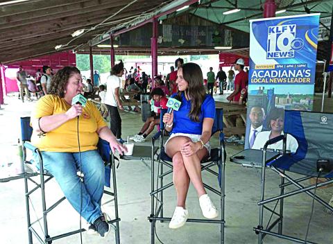 SPREADING THE WORD - Melissa Clavier (left) visits with Lidia Alcala of KLFY-TV 10 under the Pig Barn at this year’s La. Swine Festival. The Lafayette station was live at the festival on Friday, November 1, to share the schedule and the history of the festival with all of Acadiana. (LSN photo by Darrel LeJeune)