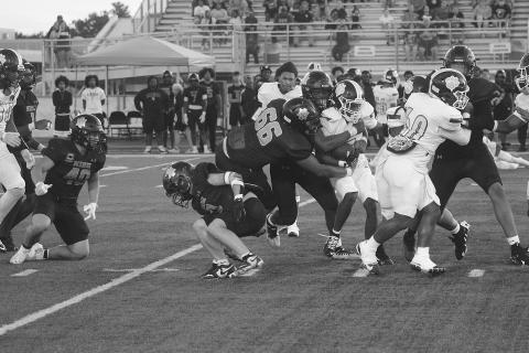 Kaiden Freeman (60) provides running room for Kendarius Doucet (15) as he finds running room against the New Iberia Senior High Yellow Jackets last Friday night. (Gazette photo by Tony Marks)