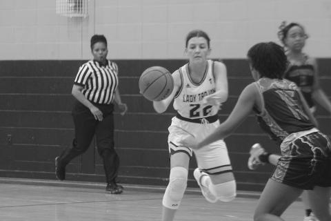 Lady Trojans’ Kali Shiver (22) looks to pass the basketball down the court in her team’s win against North Central. (Gazette photo by Rhett Manuel)
