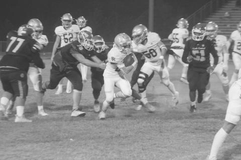 Jude Hebert (23) finds running room for his Sacred Heart Trojans in their 42-6 win over North Central Thursday night. (Gazette photo by Rhett Manuel)