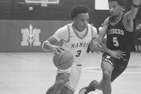 Zamaurri Brown (3) moves the basketball toward Mamou’s goal in the Green Demons’ 69-45 home loss against Northwest last Friday night. (Gazette photo by Tony Marks)