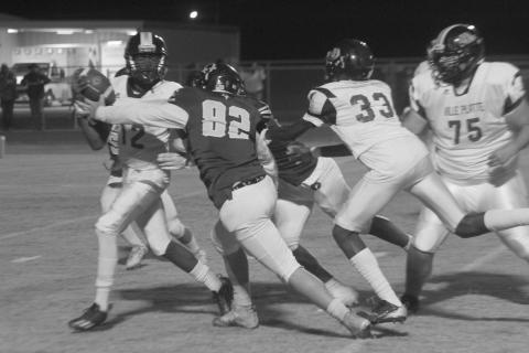 Ville Platte’s Braylin Griffin (12) attempts to get rid of the football before being taken down by Oberlin’s Kadyn Dart (82) in the regular season finale last Friday night. (Gazette photo by Rhett Manuel)