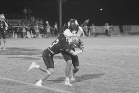Sacred Heart’s Kohen Joubert (3) attempts to bring down an Opelousas Catholic ball carrier last Friday night. (Gazette photo by Rhett Manuel)