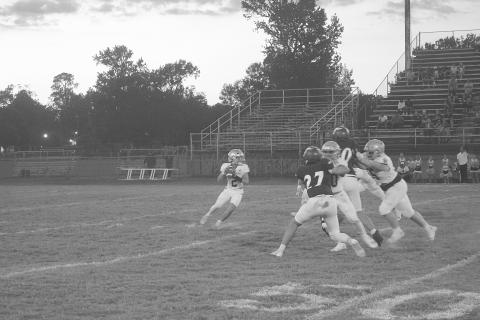 Sacred Heart quarterback Ellis Fusilier (2) drops back in the pocket and looks to deliver a pass in Trojans’ 42-0 loss against the Opelousas Catholic Vikings to begin district play. (Gazette photo by Tony Marks)