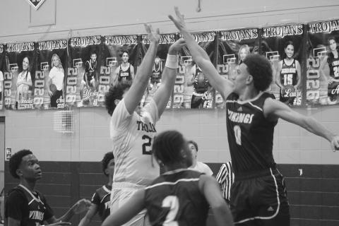Lane Joubert (24) finishes his attempt at a basket in Sacred Heart’s district opening loss to Opelousas Catholic. Joubert led the Trojans with 12 points. (Gazette photo by Tony Marks)