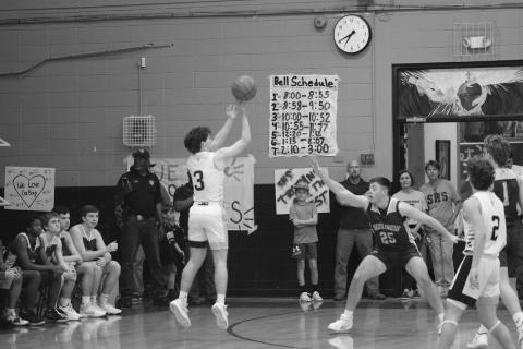Gabe Fontenot (3) shoots the basketball from beyond the arc. Fontenot’s Trojans closed out the game with a win  before ending the season with a loss against Southern Lab in the second round of the playoffs. (Gazette photo by Tony Marks)
