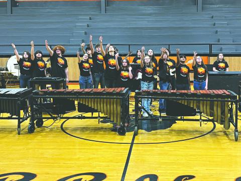 PPHS PERCUSSION ENSEMBLE SHOWS OFF TALENT - The PPHS Percussion Ensemble raises their hands at the close of their performance of their show “Steps to the Horizon.” (Gazette photo by Heather Bogard)