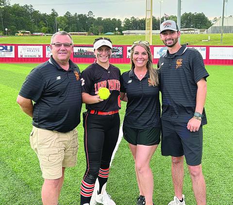 Pine Prairie Lady Panther Camron Lafleur delivered a two-run home run in the top of the seventh inning that sent her team past Many and into the quarterfinal round against the winner of the game between Sterlington and Pine. From left are assistant coach Craig Whittington, Lafleur, head coach Alycia Hebert, and assistant coach Hunter Arnaud. (Photo courtesy of Pine Prairie High School Softball)
