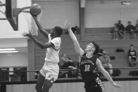 With Elizabeth’s Owen Soileau (11) not far behind, Pine Prairie’s Da’Jon Lemalle (1) scores a basket in his team’s 55-53 loss at home Tuesday night. Lemalle finished the game with 19 points to lead the Panthers. (Gazette photo by Tony Marks)
