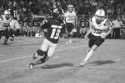 Pine Prairie’s Keadon Blood (12) tries to keep pace with Church Point’s Jarrison Reese (13). (Gazette photo by Tony Marks)