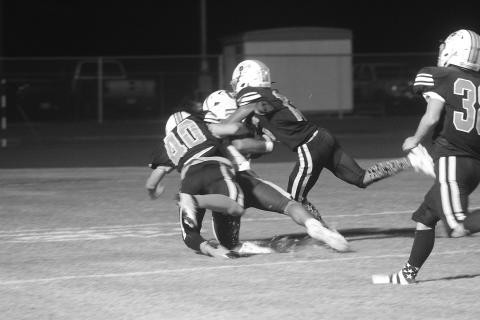 Braylon Johnson (40) and Jayland Duplechin (13) combine for a tackle on a Crowley player near the goal line in Pine Prairie’s 48-0 loss Thursday night at home. (Gazette photo by Tony Marks)