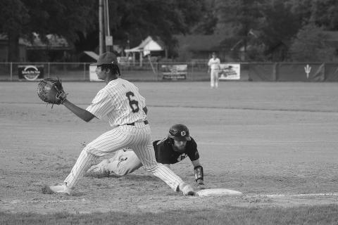 Mamou’s Ian Tezeno (6) attempts to make a play as Pine Prairie’s Kyle Basco (16) slides back safely at first base. (Gazette photo by Tony Marks)