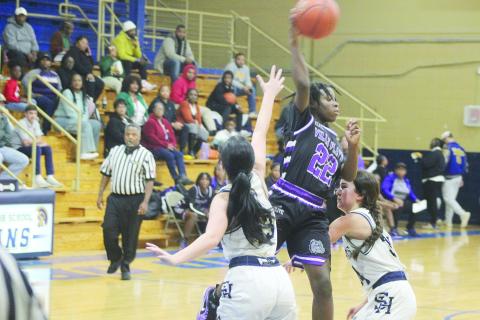 Brileyah Freeman (22) looks to pass the basketball to a Lady Bulldog teammate while being defended by Sacred Heart’s Olivia Tate (13) and Riley St. Cyr (34) in Ville Platte’s 51-38 win to open up the parish tournament.