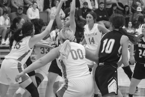 While being swarmed by Lady Hornets, Pine Prairie’s Kylie Veillon (13) attempts a basket. (Gazette photo by Tony Marks)