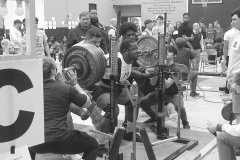 Alex Dick, of Mamou High School, squats in the Sacred Heart Invitational. His best mark in the event was 585 pounds, and his total mark on the day in all three events was 1,450 pounds. (Gazette photo by Tony Marks)