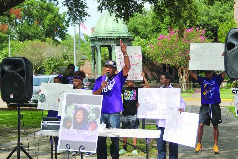 JULY 16 - Family members and friends of Brittany Fontenot are pictured as they gather for a peaceful protest at the courthouse. In the center is Hamilton Frank, an uncle of the victim. (Gazette photo by Tony Marks)
