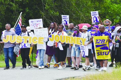 Protesters gather outside the GEO South Louisiana Detention Center in Basile on Monday, June 30. Among them were Joseph Bryant, international executive director of Service Employees International Union (SEIU).   (Photo by Robert Stewart of Verite News)