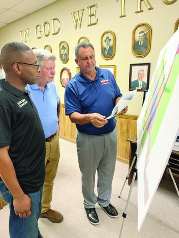 Purvis Morrison (right) reviews a map depicting areas of the proposed land use policy. Also pictured are Councilmen Mike Perron (center) and Jordan Anderson (left). (Gazette photo by Tony Marks)