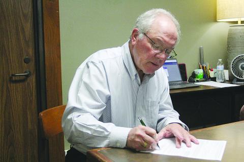 Evangeline Parish Clerk of Court Randy Deshotel was the first person to qualify for the upcoming October elections. Qualifying began on Tuesday, August 8, and runs will end today, August 10, at 4:30 p.m. Deshotel is seeking his fourth term as clerk and is pictured as he signs the form which will be sent to the secretary of state’s office. (Gazette photo by Tony Marks)