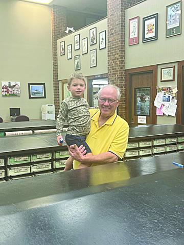 Evangeline Parish Clerk of Court Randy Deshotel celebrates his election night victory with his grandson, Stetson Fontenot. (Gazette photo by Tony Marks)