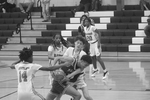 Braxton Ardoin (11) fights through traffic to collect a basket for Mamou in the Green Demons’ 70-40 win over Rapides last season. (Gazette photo by Tony Marks)
