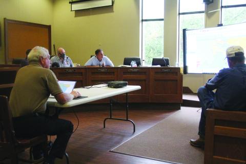 Demographer Mike Hefner (seated on the left) presents a proposed reapportionment plan to the Evangeline Parish Police Jury. Jurors pictured (from left) are Ryan Ardoin, Eric Soileau, Kevin Veillon, and Sidney Fontenot. (Gazette photo by Tony Marks)