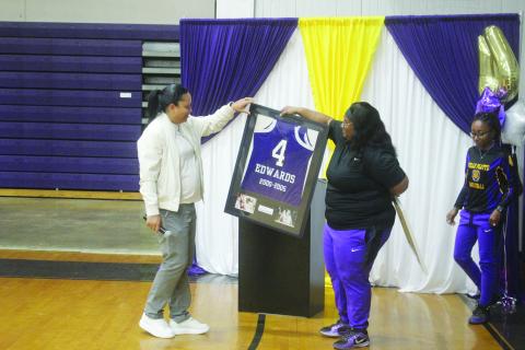 Ville Platte Lady Bulldog head coach Rhonda Thomas (right) presents a framed jersey to her former high school teammate Renotta Edwards (left). Edwards’ jersey is now retired and is on display in the school’s trophy case. (Gazette photo by Tony Marks)