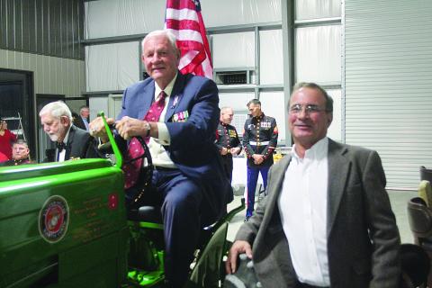Major General Ronald J. Richard sits atop his grandfather’s tractor that was restored by Tom Klumpp (right) owner of Klumpp Equipment on the Basile Eunice Highway. Klumpp was one of the hosts for a Marine Corps Birthday Ball held Wednesday, November 10, that celebrated the 246th birthday of the United States Marine Corps. (Gazette photo by Tony Marks)
