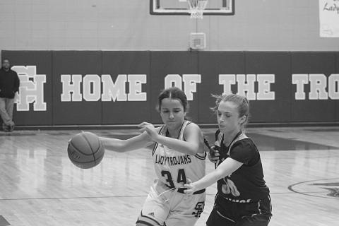 Sacred Heart’s Riley St. Cyr (34) moves the ball down the court in the Lady Trojans game against Opelousas Catholic earlier this season. The team now has a first-round bye in the playoffs. (Gazette photo by Tony Marks)