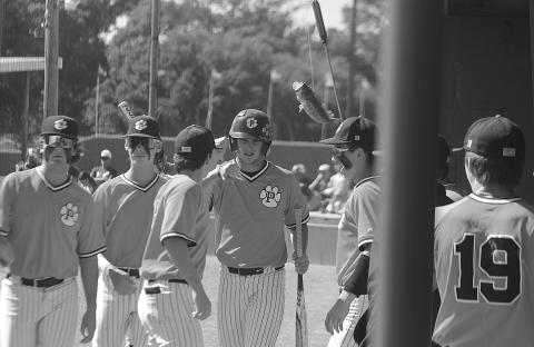 Members of the Pine Prairie baseball team celebrate with Benny the Bass after Cayden McCollough (2) scores the lone Panther run in the top of the first inning of Game 1 against Rosepine on Friday, April 28. (Gazette photo by Tony Marks)