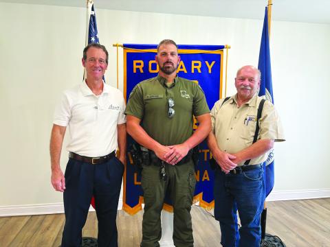 CHANGES IN HUNTING AND FISHING REGULATIONS DISCUSSED -  Corporal Mike Darbonne with the LDWF (center) shared several changes  to the 2024-2025 state hunting and fishing regulations. He is shown with Rotarian Richard LeJeune (left) and Rotary President Bob Manuel (right). (Gazette photo by Heather Bogard)