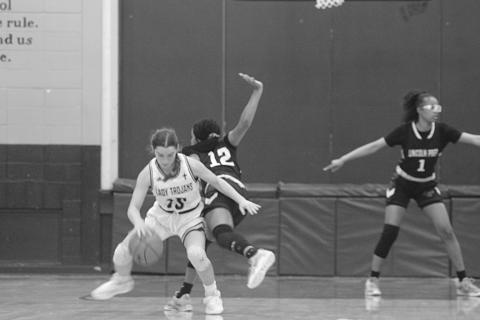 Ava Johnson (15) spins around a Lincoln Prep defender in Sacred Heart’s 58-21 disposal of the Lady Panthers in the opening round of the Select Division IV playoffs. The Lady Trojans now travel to Delta Charter for their second round matchup on Monday. (Gazette photo by Rhett Manuel)