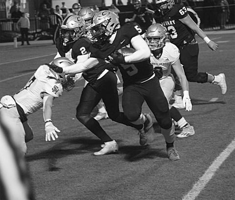 The Sacred Heart defense combines for a stop against Calvary Baptist in the Trojans’ quarterfinal loss, 63-7, in Shreveport Friday night. (Gazette photo by Rhett Manuel)