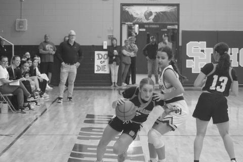 Pine Prairie’s Josie Vidrine (3) dribbles around Sacred Heart’s Riley St. Cyr (34) in the Lady Panthers’ 62-52 loss to the Lady Trojans on Tuesday night. (Gazette photo by Tony Marks)