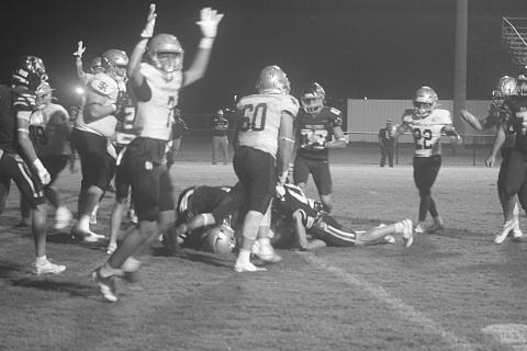 Sacred Heart’s Aaron LeJeune (7) celebrates as Trojans’ quarterback Ellis Fusilier scores a 1-yard touchdown against Iota in the jamboree at St. Edmund. (Gazette photo by Tony Marks)
