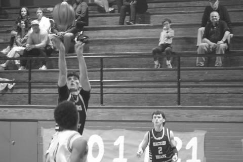 In his last game wearing the Sacred Heart basketball uniform, Seth Guillory (34) attempts a basket in the Trojans’ 58-33 loss to Opelousas Catholic in the first round of the playoffs. (Gazette photo by Tony Marks)