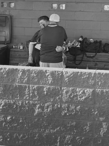 A tearful Hayden Fontenot gets consoled in the Trojan dugout after his team dropped Game 3 of the best-of-three series against Ouachita Christian on Saturday, May 7.  (Gazette photo by Rhett Manuel)