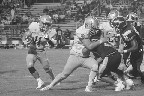 Ashton Duos (11) looks to turn a corner and pick up positive yardage in Sacred Heart’s regular season opening win against Oakdale, 32-0. (Gazette photo by Tony Marks)