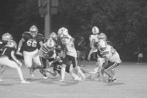 Sacred Heart’s Sully Manuel (13) makes a diving tackle on Pine Prairie’s Rhett Guillory (33) in the Trojans’ 42-0 win over the Panthers. (Gazette photo by Tony Marks)