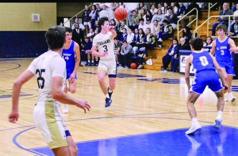 Ellis Chapman (3) passes the ball to a Trojan teammate in Sacred Heart’s 59-34 win over St. Edmund last Friday night. (LSN photo by Rhett Manuel)