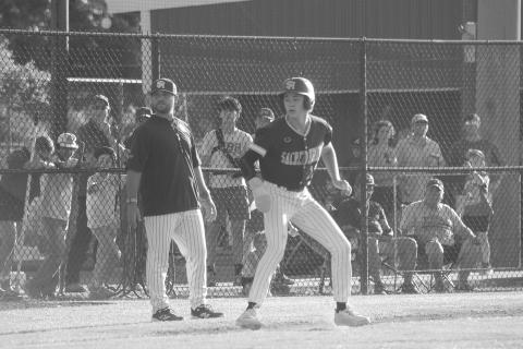 Sully Manuel (13) eyes home plate as he takes his lead off the third base bag during Sacred Heart’s 3-2 playoff loss to St. Edmund on Sunday, May 3. (Gazette photo by Tony Marks)