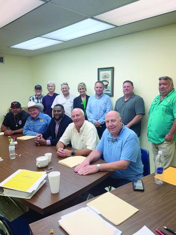 From left are (standing) Turkey Creek Mayor Bert Campbell, Evangeline Parish School Board member Karen Vidrine, Evangeline Parish Secretary-Treasurer Dirk Deville, Mamou Mayor Leisa Deshotel, Pine Prairie Mayor Quint West, Basile Mayor Mark Denette, and Chataignier Mayor Justin Darbonne; (sitting) Ville Platte Mayor Ryan LeDay Williams, Evangeline Parish Sheriff Charles Guillory, incoming administrator Cody Jones, outgoing administrator Marty Morein, and Evangeline Solid Waste Commission Executive Director 