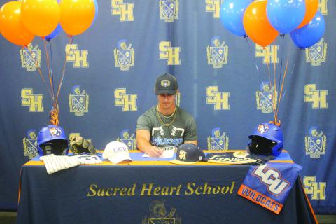 Sam Veillon, formerly of Sacred Heart, is pictured as he signs to play baseball at Louisiana Christian University during a  ceremony held Wednesday, July 2. (Gazette photo by Tony Marks)