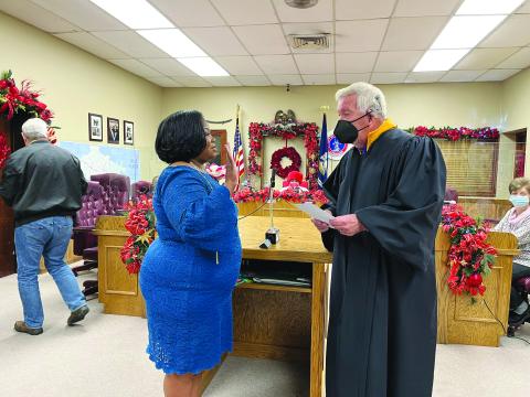 SAM SWORN IN - Judge John Larry Vidrine, right, administers the oath of office to Christina Sam, new Ville Platte City Council member representing District E. She is taking the place of her late husband, Donald Sam. (Gazette photo by Heather Bogard)