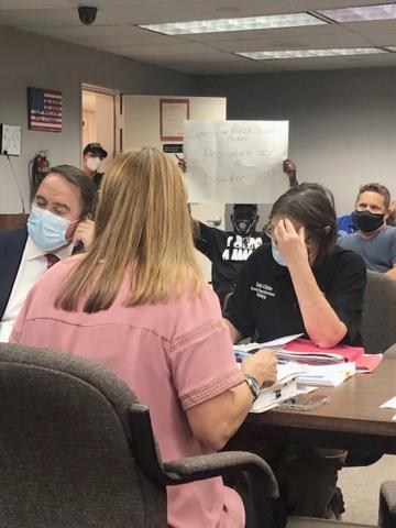 Arthur Sampson is pictured holding a poster at Wednesday’s meeting of the Evangeline Parish School Board. The poster reads “Evangeline Parish School Board President Is A Dictator???” It is in response to the board not allowing Sampson to speak at the last meeting. (Gazette photo by Tony Marks)