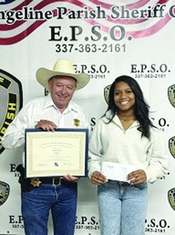 Evangeline Parish Sheriff Charles Guillory is pictured on the left as he presents an academic scholarship to Jaidan Richard, of Mamou. (Photo courtesy of EPSO)